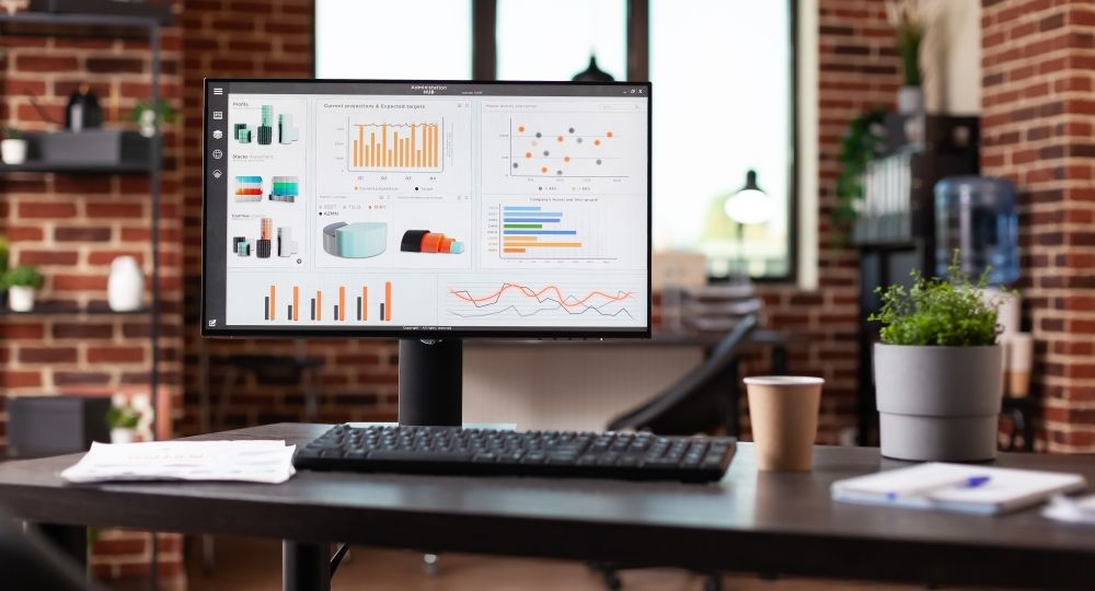 Nobody in office with business data charts on monitor