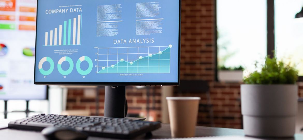 Monitor with charts with annual data analysis on screen